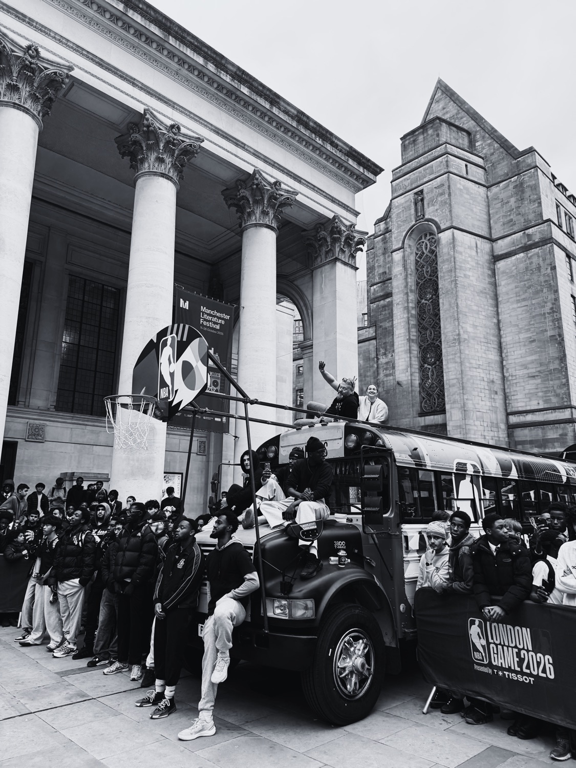 The STREETBUS and crowd outside a city building