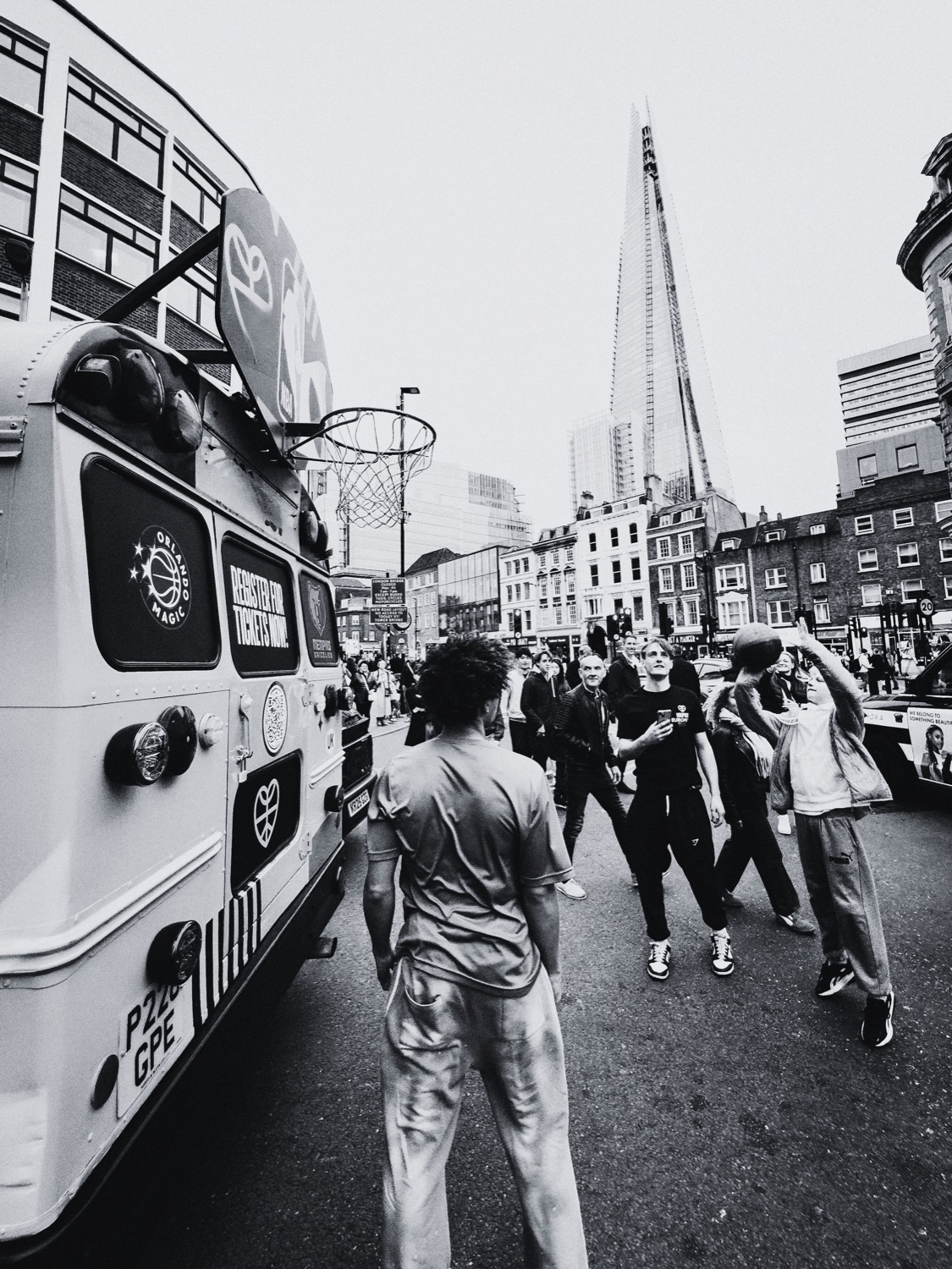 People playing basketball beside the STREETBUS in the city